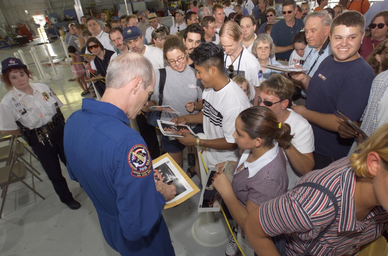 JSC2001-E-25826 (23 August 2001) --- Daniel T. Barry, STS-105 mission specialist, signs autographs for the assembled crowd in Hangar 990 at Ellington Field during the STS-105 and Expedition Two crew return ceremonies. The STS-105 crew delivered the Expedition Three crew and supplies to the International Space Station (ISS) and brought the Expedition Two crew back to Earth.