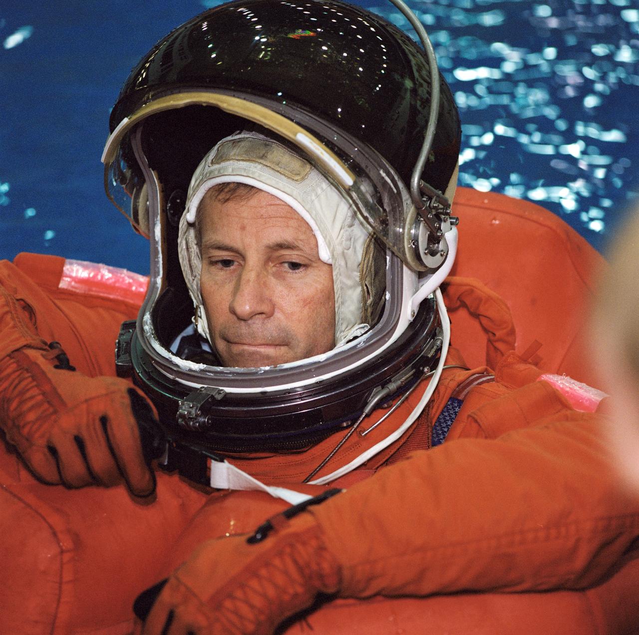 JSC2002-00403 (4 February 2002) --- Astronaut Kenneth D. Cockrell, STS-111 mission commander, attired in a training version of the shuttle launch and entry garment, floats in the deep pool during a training session at the Neutral Buoyancy Laboratory (NBL) near the Johnson Space Center (JSC). STS-111 will be the 14th shuttle mission to visit the International Space Station (ISS).