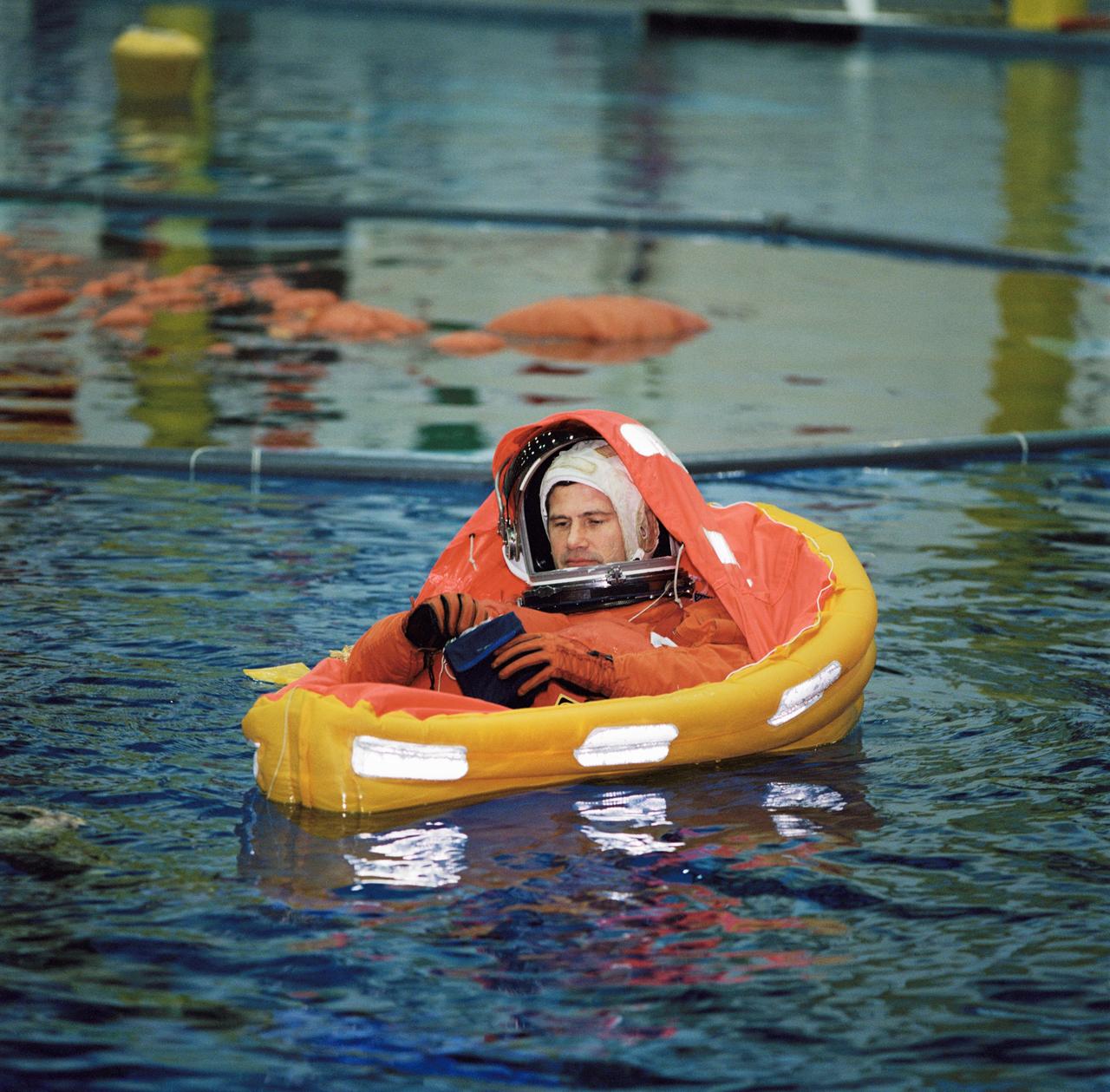 JSC2002-00404 (4 February 2002) --- Astronaut Paul S. Lockhart, STS-111 pilot, floats in a small life raft during an emergency bailout training session in the Neutral Buoyancy Laboratory (NBL) near the Johnson Space Center (JSC). STS-111 will be the 14th shuttle mission to visit the International Space Station (ISS).