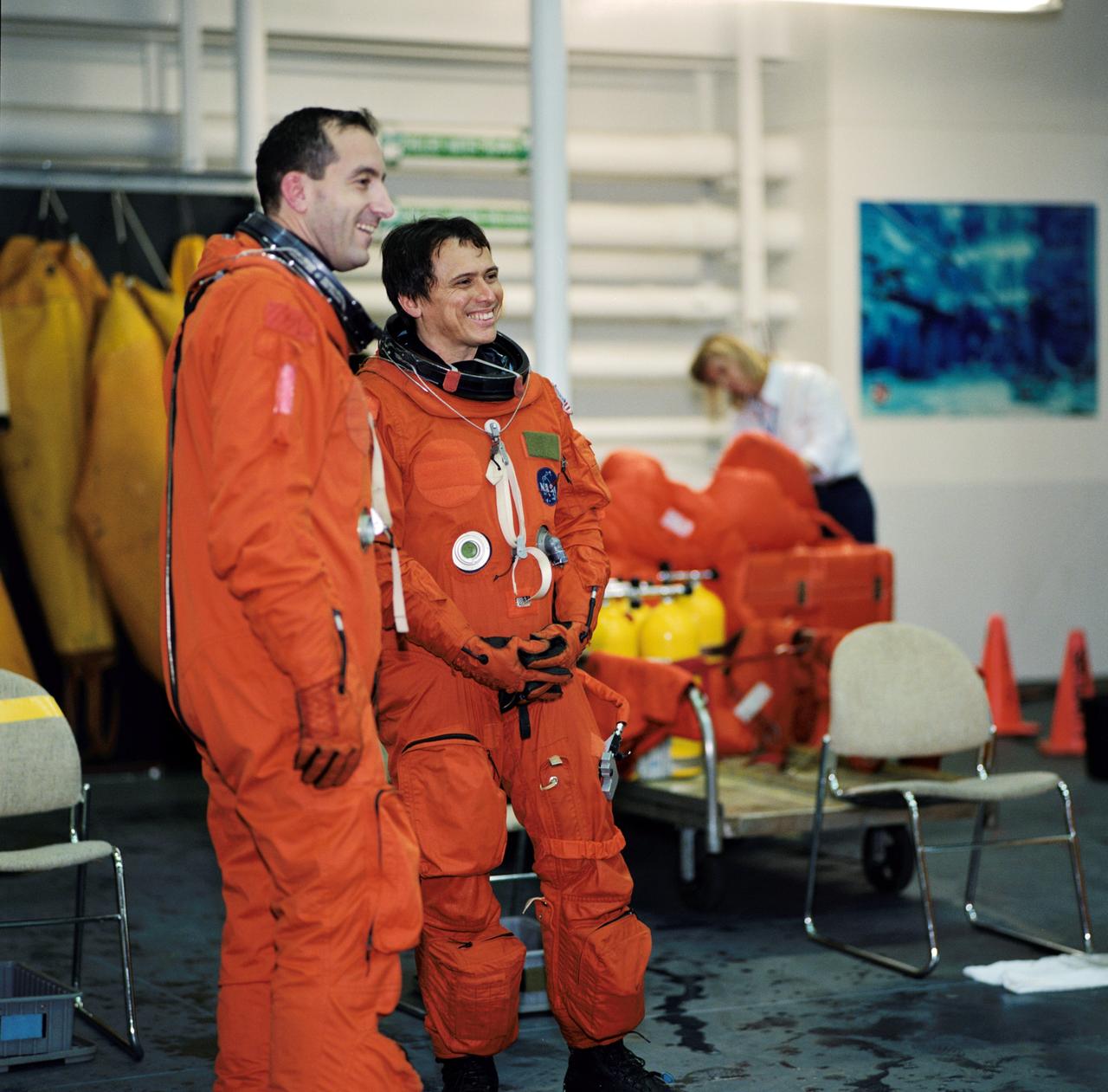 JSC2002-00405 (4 February 2002) --- Astronauts Philippe Perrin (left) and Franklin R. Chang-Diaz, both STS-111 mission specialists attired in training versions of the shuttle launch and entry garment, await the start of a training session at the Neutral Buoyancy Laboratory (NBL) near the Johnson Space Center (JSC). STS-111 will be the 14th shuttle mission to visit the International Space Station (ISS).