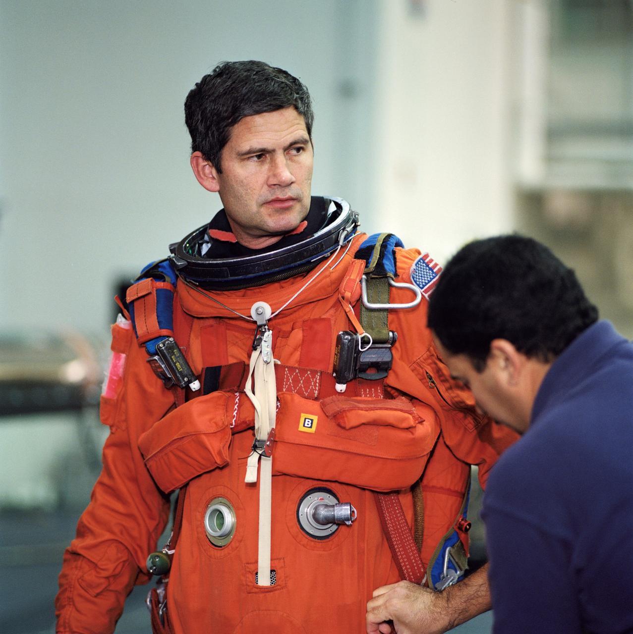 JSC2002-00419 (4 February 2002) --- Astronaut Paul S. Lockhart, STS-111 pilot, gets help with final touches on the training version of the shuttle launch and entry garment as he prepares for the start of an emergency bailout training session at the Neutral Buoyancy Laboratory (NBL) near the Johnson Space Center (JSC). STS-111 will be the 14th shuttle mission to visit the International Space Station (ISS).