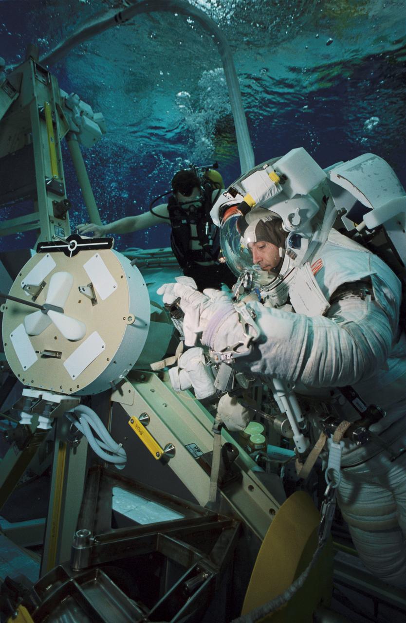 JSC2002-00508 (15 January 2002) --- Astronaut Philippe Perrin, STS-111 mission specialist, wears a training version of the Extravehicular Mobility Unit (EMU) space suit during an underwater simulation of extravehicular activity (EVA) scheduled for the 14th shuttle mission to the International Space Station (ISS). Perrin, representing CNES, the French Space Agency, was joined by astronaut Franklin R. Chang-Diaz (out of frame) for the simulation, conducted in the Neutral Buoyancy Laboratory (NBL) near the Johnson Space Center.