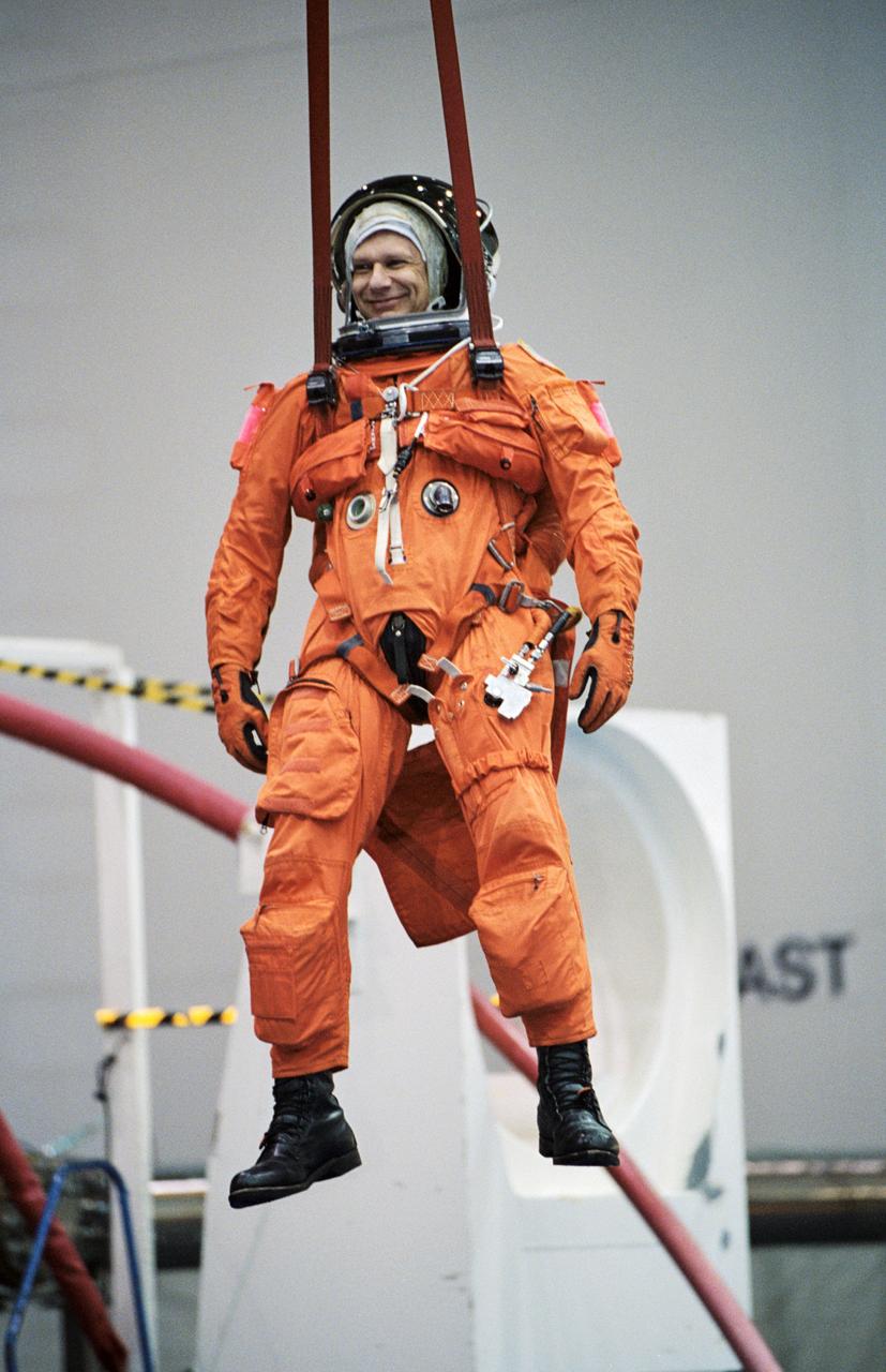 JSC2002-00515 (19 February 2002) --- Astronaut Piers J. Sellers, STS-112 mission specialist, simulates a parachute drop into water during an emergency bailout training session at the Neutral Buoyancy Laboratory (NBL) near the Johnson Space Center (JSC). Sellers is attired in a training version of the shuttle launch and entry suit.