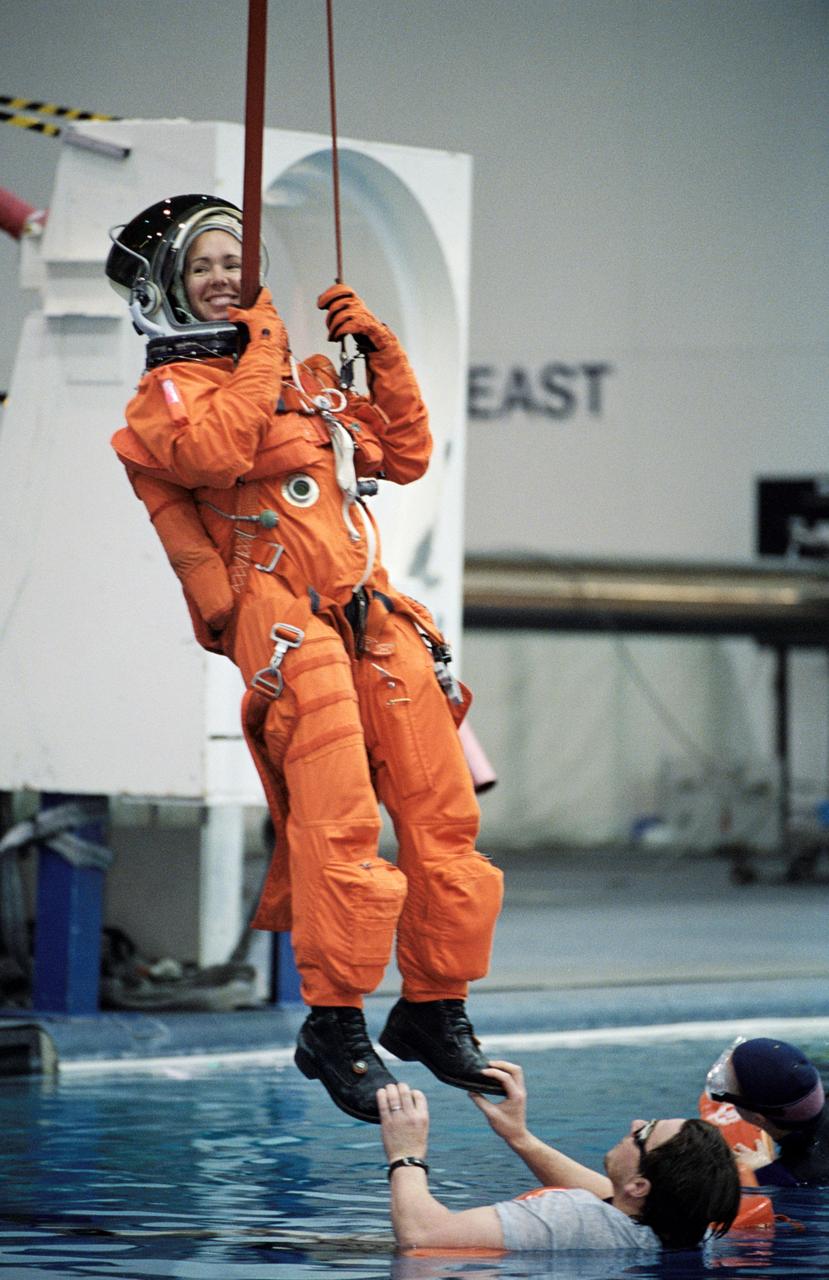 JSC2002-00518 (19 February 2002) --- Astronaut Sandra H. Magnus, STS-112 mission specialist, simulates a parachute drop into water during an emergency bailout training session at the Neutral Buoyancy Laboratory (NBL) near the Johnson Space Center (JSC). Magnus is attired in a training version of the shuttle launch and entry suit.