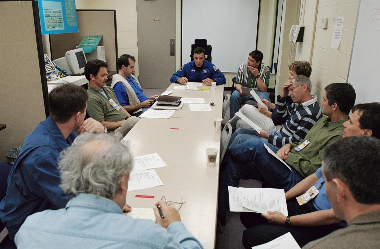 JSC2002-00723 (29 March 2002) --- The STS-111 crewmembers and the Expedition Five crewmembers share a joint planning session in the Space Vehicle Mockup Facility at Johnson Space Center (JSC). Seated on the right side of the conference table are cosmonaut Valeri G. Korzun (foreground), Expedition Five mission commander, astronauts Franklin R. Chang-Diaz, STS-111 mission specialist, Paul S. Lockhart, STS-111 pilot, Kenneth D. Cockrell, STS-111 mission commander, and Peggy A. Whitson, Expedition Five flight engineer. Seated on the left side of the conference table are cosmonaut Sergei Y. Treschev (foreground), Expedition Five flight engineer, and astronaut Philippe Perrin (far end), STS-111 mission specialist. Korzun and Treschev represent Rosaviakosmos and Perrin represents CNES, the French Space Agency.