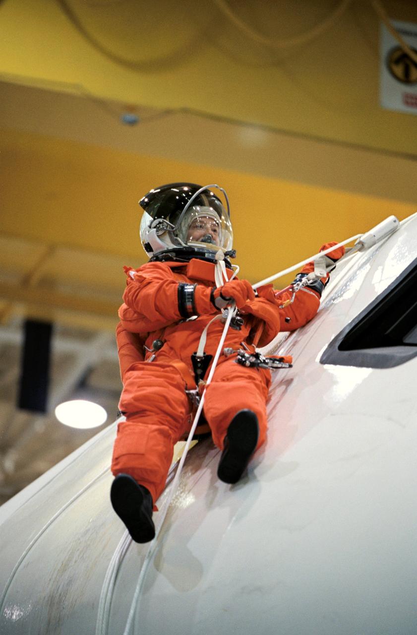 JSC2002-00863 (24 April 2002) --- Astronaut Pamela A. Melroy, STS-112 pilot, uses a device called a Sky genie to simulate rappelling from a troubled shuttle in a training session in the Space Vehicle Mockup Facility at the Johnson Space Center (JSC). The mockup is called the Full Fuselage Trainer (FFT). This exercise trains the crewmembers for procedures to follow in egressing a troubled shuttle on the ground.