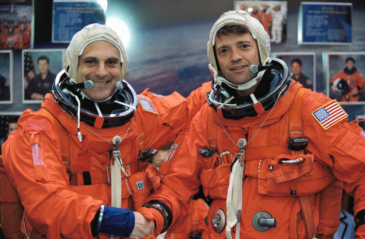 JSC2002-00870 (24 April 2002) --- Astronauts Jeffrey S. Ashby (right) and David A. Wolf, STS-112 mission commander and mission specialist, respectively, are photographed prior to a mission training session in the Space Vehicle Mockup Facility at the Johnson Space Center (JSC). Ashby and Wolf are attired in training versions of the shuttle launch and entry suit.