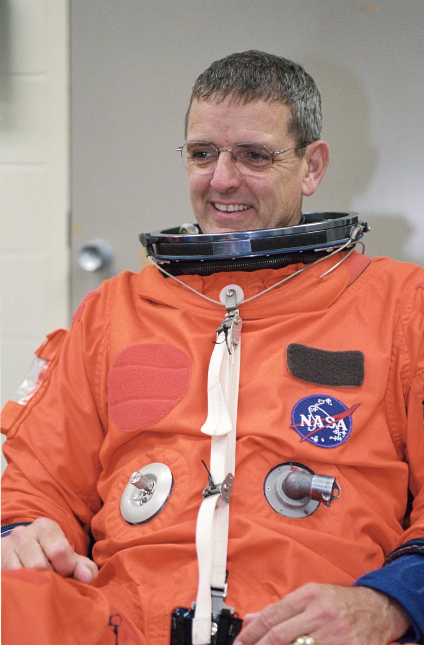 JSC2002-01517 (8 Aug. 2002) --- Astronaut William S. (Bill) McArthur, Jr., Expedition 12 commander, attired in a training version of the shuttle launch and entry suit, awaits the start of a mission training session in the Space Vehicle Mockup Facility at NASA's Johnson Space Center.