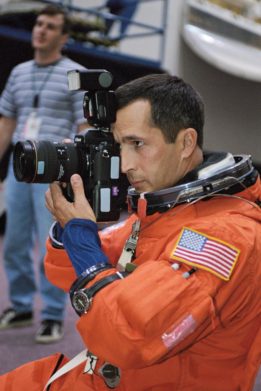 JSC2002-01738 (17 September 2002) --- Astronaut John B. Herrington, STS-113 mission specialist, uses a still camera prior to the start of a training session in the Space Vehicle Mockup Facility at the Johnson Space Center (JSC). Herrington is wearing a training version of the shuttle launch and entry suit.