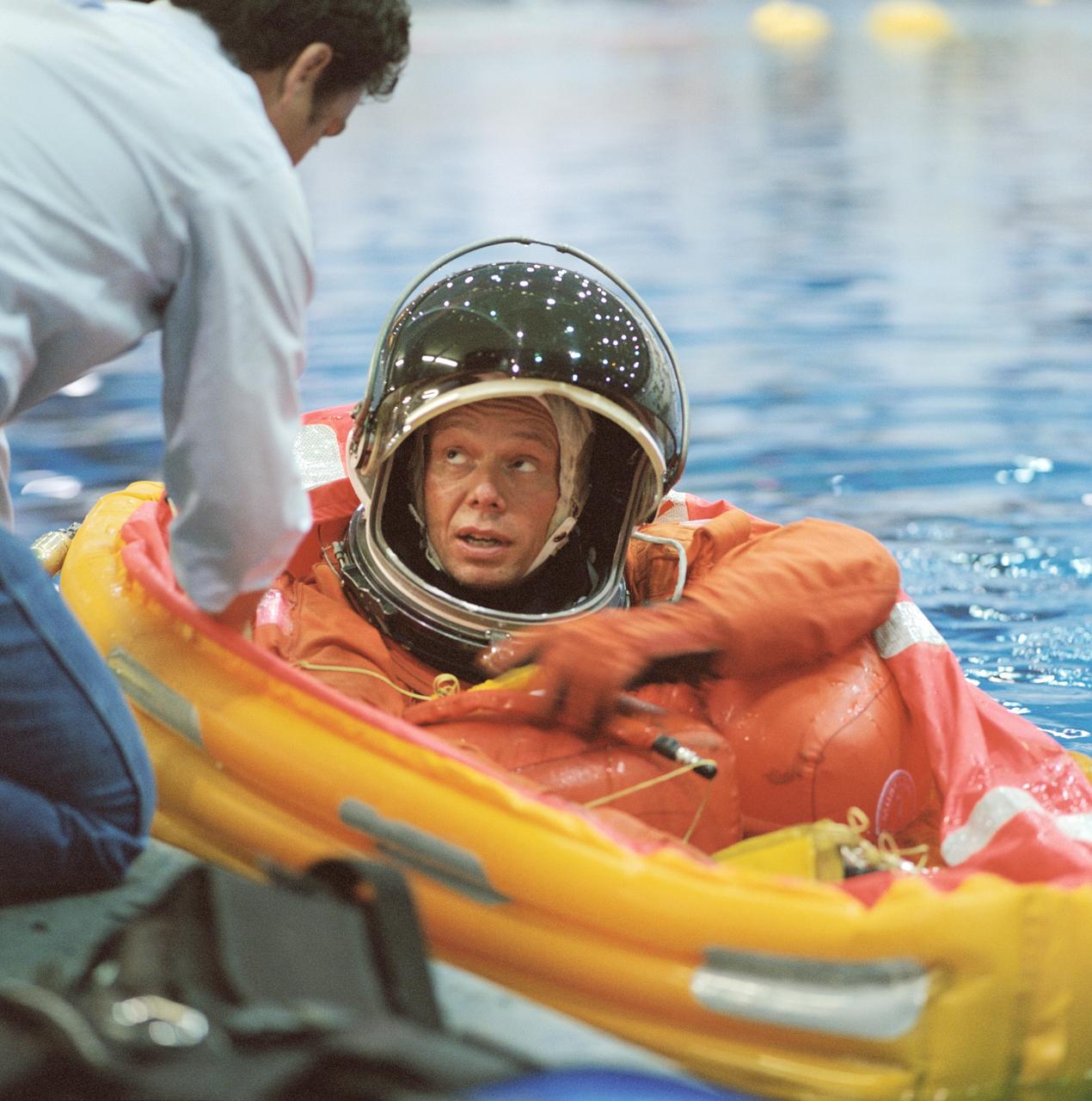 JSC2002-01762 (20 September 2002) --- Astronaut Christer Fuglesang, STS-116 mission specialist, floats in a small life raft during an emergency bailout training session in the Neutral Buoyancy Laboratory (NBL) near the Johnson Space Center (JSC). Fuglesang, who represents the European Space Agency (ESA), is attired in a training version of the shuttle launch and entry suit.