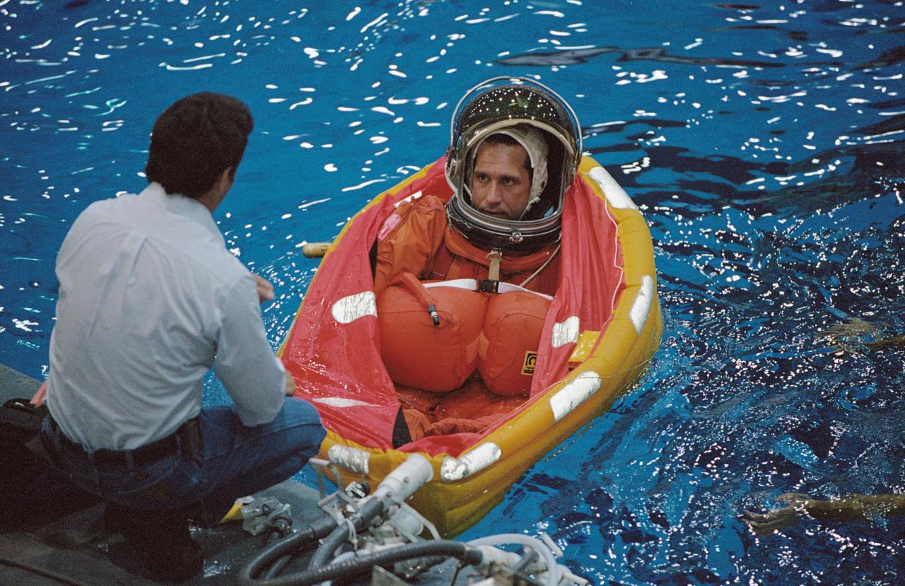 JSC2002-01775 (20 September 2002) --- Astronaut William A. Oefelein, STS-116 pilot, floats in a small life raft during an emergency bailout training session in the Neutral Buoyancy Laboratory (NBL) near the Johnson Space Center (JSC). Oefelein is attired in a training version of the shuttle launch and entry suit.