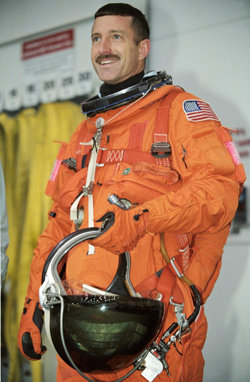 JSC2002-01927 (21 October 2002) --- Astronaut Daniel C. Burbank, STS-115 mission specialist, attired in a training version of the shuttle launch and entry suit, awaits the start of an emergency training session in the Neutral Buoyancy Laboratory (NBL) near the Johnson Space Center (JSC).