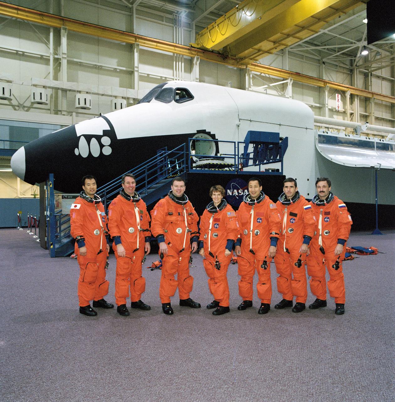 JSC2002-02020 (12 November 2002) --- The STS-114 and Expedition Seven crews, attired in training versions of the full-pressure launch and entry suit, pose for a group photo prior to a training session in the Space Vehicle Mockup Facility at the Johnson Space Center (JSC). From the left are astronauts Soichi Noguchi, Stephen K. Robinson, both STS-114 mission specialists; James M. Kelly, STS-114 pilot; Eileen M. Collins, STS-114 mission commander; Edward T. Lu, Expedition Seven flight engineer; cosmonauts Yuri I. Malenchenko, Expedition Seven mission commander; and Alexander Y. Kaleri, Expedition Seven flight engineer. Noguchi represents Japan&#0146;s National Space Development Agency (NASDA). Malenchenko and Kaleri represent Rosaviakosmos.