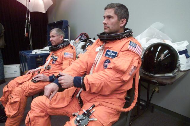 JSC2002-E-07961 (22 February 2002) --- Astronauts Kenneth D. Cockrell (left) and Paul S. Lockhart, STS-111 mission commander and pilot, respectively, wait for a photo session in a studio at Johnson Space Center (JSC). Cockrell and Lockhart are attired in training versions of the launch and entry garment.