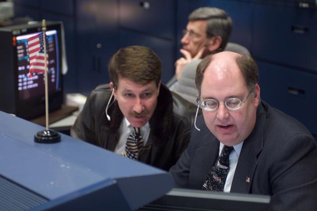 JSC2002-E-08147 (1 March 2002) --- Astronaut Kent V. Rominger (left), Wayne Hale, and Lawrence Bourgeois (background), monitor pre-flight data at the Mission Operation Directorate (MOD) console in the shuttle flight control room (WFCR) in Houston's Mission Control Center (MCC). Several hundred miles away in Florida, the STS-109 crewmembers were awaiting countdown in the crew cabin of the Space Shuttle Columbia on the launch pad at the Kennedy Space Center (KSC). As soon as the vehicle cleared the tower in Florida, the Houston-based team of flight controllers took over the ground control of the mission. Rominger is the Deputy Director of the Flight Crew Operations Directorate (FCOD) and was the FCOD management representative in the MCC. Hale, the Deputy Chief for Space Shuttle of the Flight Director’s Office, served as the MOD management representative. Bourgeois is the Mission Operations Director in the Flight Operations Department at United Space Alliance (USA), and was the USA management representative for STS-109.