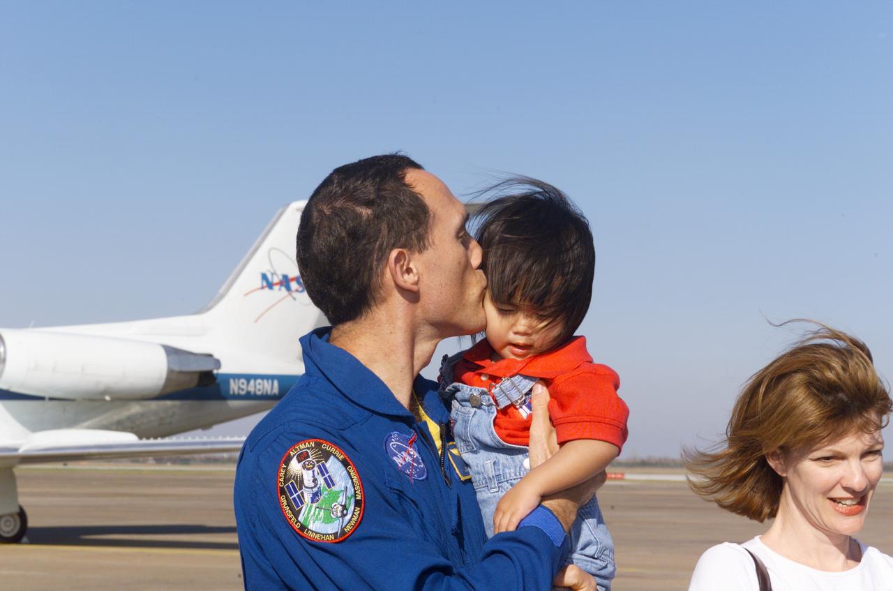 Photographic documentation of the STS-109 Crew Return Ceremony.  The events take place at Hangar 990 at Ellington Field.    Views include:  Overall view of crewmembers [09319]; View of crewmembers standing on stage talking to group [09320]; Unidentified crewmember waving to crowd [09321]; Unidentified crewmember autographing photo [09322];   Mission Specialist Michael J. Massimino holding crew photo as he talks to child in group [09323]; Pilot Duane G. Carey signing a crew photo for a visitor [09324];   Unidentified crewmember signing a photo for visitor [09325]; Commander Scott D. Altman talking to child in group [09326]; Unidentified crewmember giving a photo to visitor [09327]; Crewmembers exiting plane [09328]; Duane G. Carey shaking hands with visitor.  Astronaut Scott Altman smiling in the background [09329); Astronaut Jim Newman kissing his child [09330]; Jim Newman holding his daughter as his son grabs at his pant leg [09331]; Close-up view of Payload Commander John Grunsfeld holding his daughter [09332]; Duane G. Carey standing with family members [09333]; Close-up view of Duane G. Carey placing his hand on a child's head as he is talking to him [09334]; Overall view of spectator watching ceremony [09335]; Close-up view of speaker during ceremony [09336]; Close-up view of Scott Altman speaking to crowd [09337]; Close-up view of a young spectator at ceremony [09338]; Close-up view of Duane G. Carey speaking to the crowd [09339]; Close-up view of Mission Specialist Nancy J. Currie speaking to the crowd [09340]; Close-up view of John M. Grunsfield speaking to the crowd [09341]; Close-up view of Mission Specialist Richard M. Linnehan speaking to the crowd [09342]; Close-up view of James H. Newman speaking to the crowd [09343]; Close-up view of Michael J. Massimino speaking to the crowd [09344]