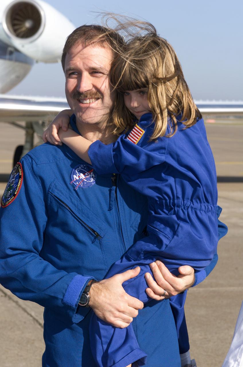 Photographic documentation of the STS-109 Crew Return Ceremony.  The events take place at Hangar 990 at Ellington Field.    Views include:  Overall view of crewmembers [09319]; View of crewmembers standing on stage talking to group [09320]; Unidentified crewmember waving to crowd [09321]; Unidentified crewmember autographing photo [09322];   Mission Specialist Michael J. Massimino holding crew photo as he talks to child in group [09323]; Pilot Duane G. Carey signing a crew photo for a visitor [09324];   Unidentified crewmember signing a photo for visitor [09325]; Commander Scott D. Altman talking to child in group [09326]; Unidentified crewmember giving a photo to visitor [09327]; Crewmembers exiting plane [09328]; Duane G. Carey shaking hands with visitor.  Astronaut Scott Altman smiling in the background [09329); Astronaut Jim Newman kissing his child [09330]; Jim Newman holding his daughter as his son grabs at his pant leg [09331]; Close-up view of Payload Commander John Grunsfeld holding his daughter [09332]; Duane G. Carey standing with family members [09333]; Close-up view of Duane G. Carey placing his hand on a child's head as he is talking to him [09334]; Overall view of spectator watching ceremony [09335]; Close-up view of speaker during ceremony [09336]; Close-up view of Scott Altman speaking to crowd [09337]; Close-up view of a young spectator at ceremony [09338]; Close-up view of Duane G. Carey speaking to the crowd [09339]; Close-up view of Mission Specialist Nancy J. Currie speaking to the crowd [09340]; Close-up view of John M. Grunsfield speaking to the crowd [09341]; Close-up view of Mission Specialist Richard M. Linnehan speaking to the crowd [09342]; Close-up view of James H. Newman speaking to the crowd [09343]; Close-up view of Michael J. Massimino speaking to the crowd [09344]