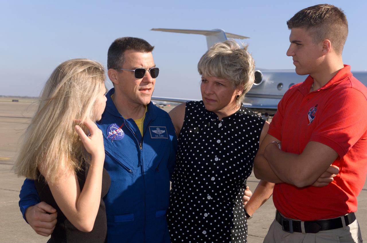 Photographic documentation of the STS-109 Crew Return Ceremony.  The events take place at Hangar 990 at Ellington Field.    Views include:  Overall view of crewmembers [09319]; View of crewmembers standing on stage talking to group [09320]; Unidentified crewmember waving to crowd [09321]; Unidentified crewmember autographing photo [09322];   Mission Specialist Michael J. Massimino holding crew photo as he talks to child in group [09323]; Pilot Duane G. Carey signing a crew photo for a visitor [09324];   Unidentified crewmember signing a photo for visitor [09325]; Commander Scott D. Altman talking to child in group [09326]; Unidentified crewmember giving a photo to visitor [09327]; Crewmembers exiting plane [09328]; Duane G. Carey shaking hands with visitor.  Astronaut Scott Altman smiling in the background [09329); Astronaut Jim Newman kissing his child [09330]; Jim Newman holding his daughter as his son grabs at his pant leg [09331]; Close-up view of Payload Commander John Grunsfeld holding his daughter [09332]; Duane G. Carey standing with family members [09333]; Close-up view of Duane G. Carey placing his hand on a child's head as he is talking to him [09334]; Overall view of spectator watching ceremony [09335]; Close-up view of speaker during ceremony [09336]; Close-up view of Scott Altman speaking to crowd [09337]; Close-up view of a young spectator at ceremony [09338]; Close-up view of Duane G. Carey speaking to the crowd [09339]; Close-up view of Mission Specialist Nancy J. Currie speaking to the crowd [09340]; Close-up view of John M. Grunsfield speaking to the crowd [09341]; Close-up view of Mission Specialist Richard M. Linnehan speaking to the crowd [09342]; Close-up view of James H. Newman speaking to the crowd [09343]; Close-up view of Michael J. Massimino speaking to the crowd [09344]