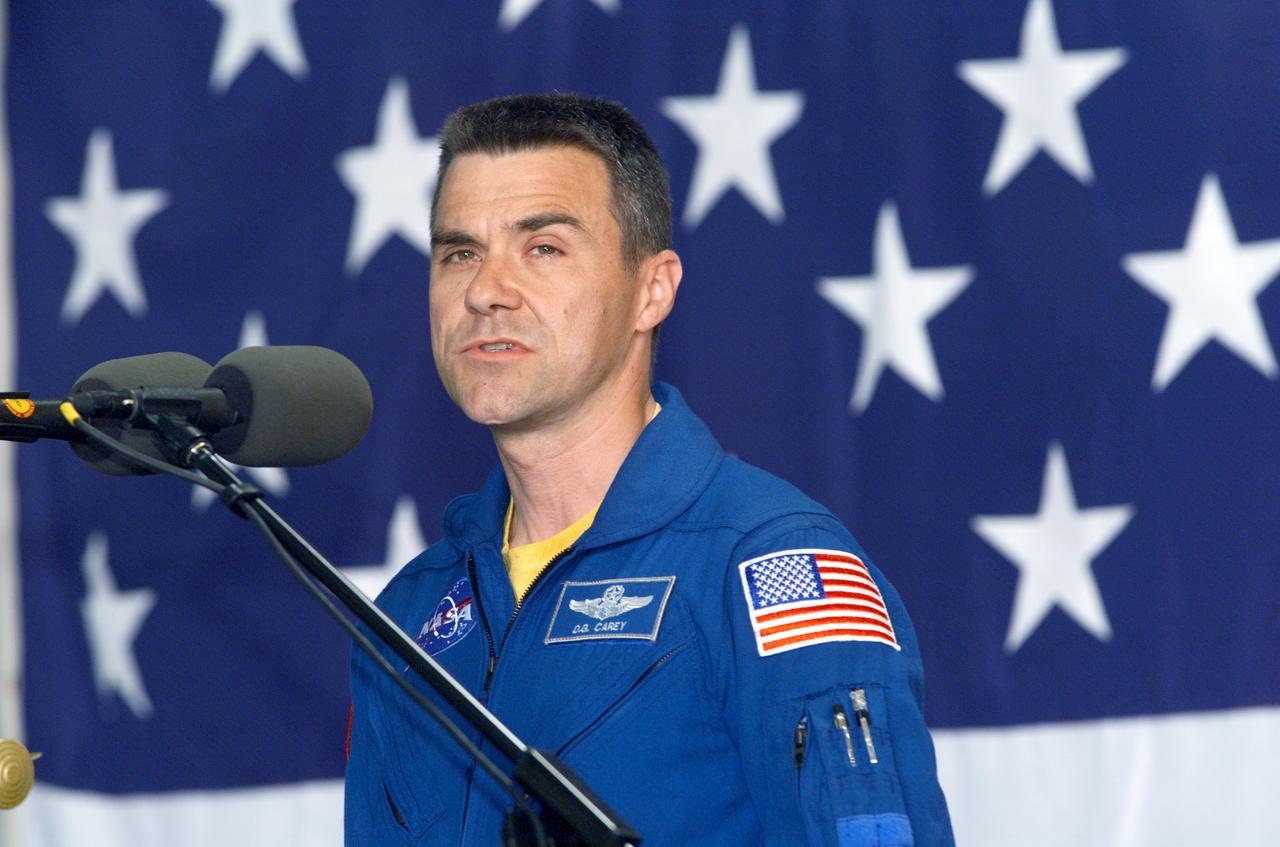 JSC2002-E-09339 (13 March 2002) --- Astronaut Duane G. Carey, STS-109 pilot, speaks from the lectern in Hangar 990 at Ellington Field during the crew return ceremonies.