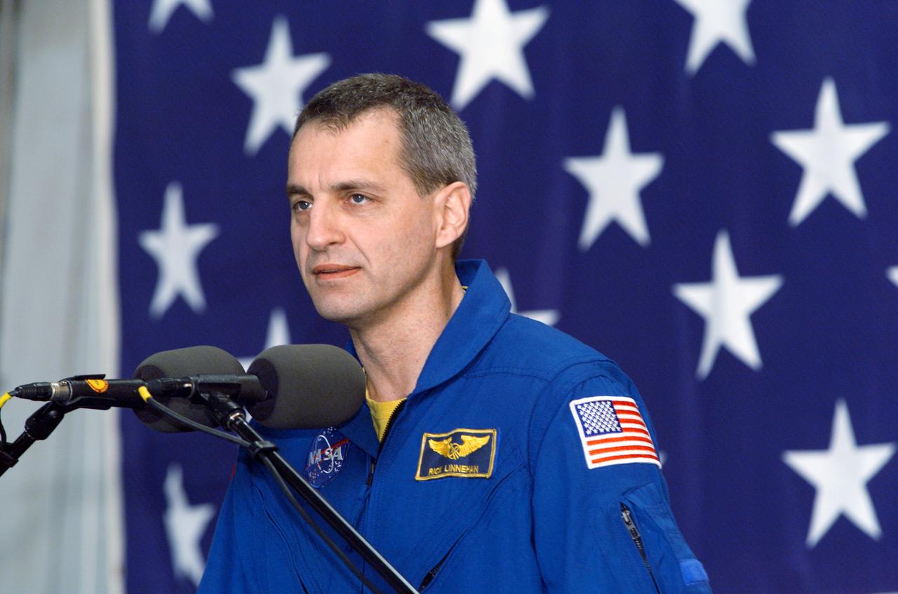 JSC2002-E-09342 (13 March 2002) --- Astronaut Richard M. Linnehan, STS-109 mission specialist, speaks from the lectern in Hangar 990 at Ellington Field during the crew return ceremonies.