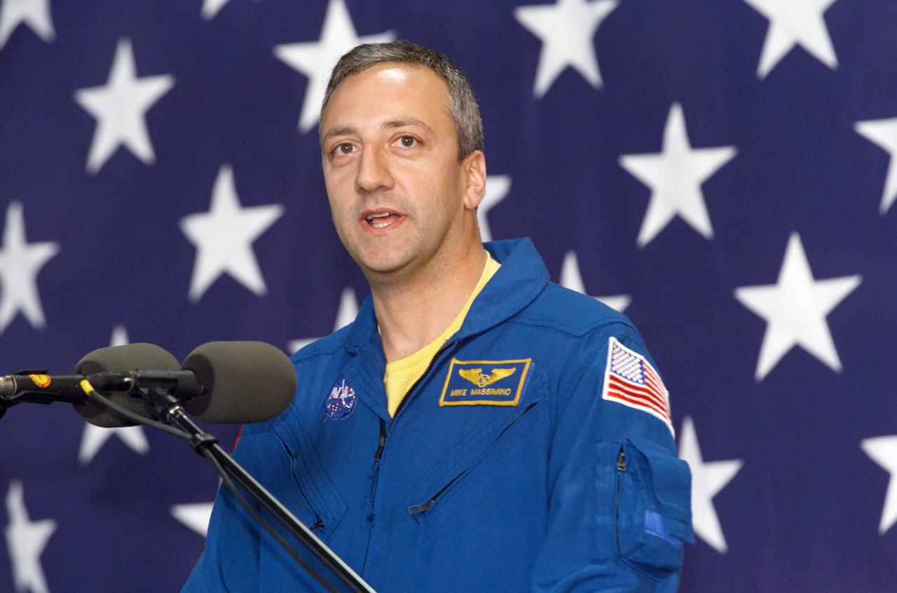JSC2002-E-09344 (13 March 2002) --- Astronaut Michael J. Massimino, STS-109 mission specialist, speaks from the lectern in Hangar 990 at Ellington Field during the crew return ceremonies.