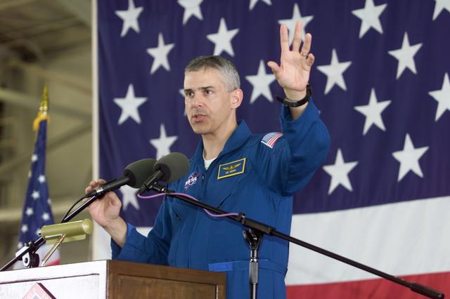 JSC2002-E-14076 (20 April 2002) --- Astronaut Lee M. E. Morin, STS-110 mission specialist, speaks from the lectern in Hangar 990 at Ellington Field during the crew return ceremonies.