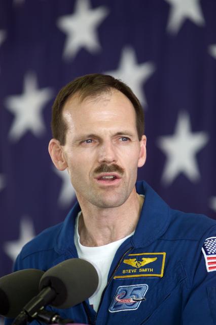 JSC2002-E-14077 (20 April 2002) --- Astronaut Steven L. Smith, STS-110 mission specialist, speaks from the lectern in Hangar 990 at Ellington Field during the crew return ceremonies.