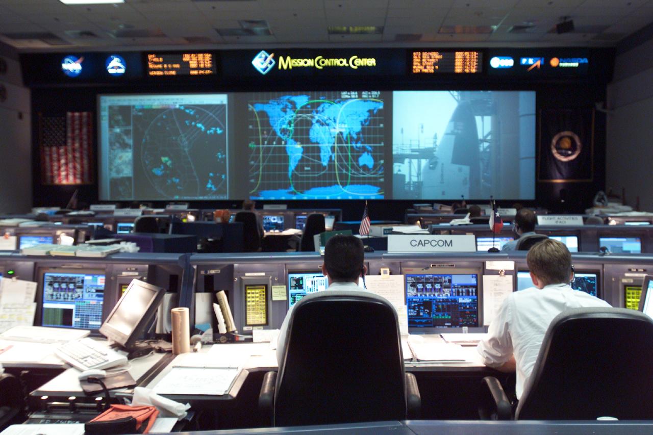 JSC2002-E-23113 (5 June 2002) --- The Space Shuttle Endeavour is shown on the big screen in this overall view of the shuttle flight control room (WFCR) in Houston&#0146;s Mission Control Center (MCC) as it is on the launch pad at Kennedy Space Center, Florida. Endeavour launched at 4:23 p.m. (CDT) on June 5, 2002. Once the vehicle cleared the tower in Florida, the Houston-based team of flight controllers took over the ground control of the flight.
