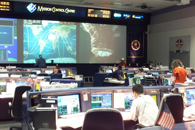 JSC2002-E-23236 (7 June 2002) --- In this overall view of the shuttle flight control room (WFCR) in Houston’s Mission Control Center (MCC), the docking of the Space Shuttle Endeavour and the International Space Station (ISS) is shown on the big screen. The docking occurred at 11:25 a.m. (CDT) on June 7, 2002.