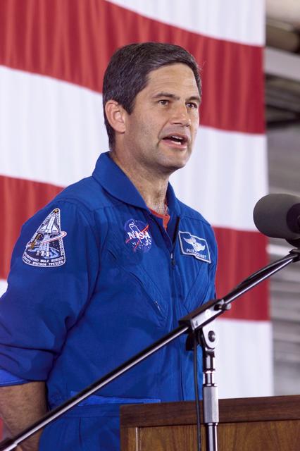JSC2002-E-25978 (21 June 2002) --- Astronaut Paul S. Lockhart, STS-111 pilot, speaks to a large crowd who showed up at Ellington Field's Hangar 990 to welcome home the STS-111 and Expedition Four crew members. The four shuttle prime crew members returned to Earth earlier in the week after two weeks in space, but for the three station crew members, this was their first time in Houston since December of 2001, having spent well over six months in Earth orbit on board the International Space Station (ISS).