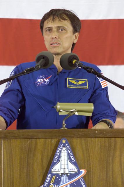 JSC2002-E-26032 (21 June 2002) --- Astronaut Franklin R. Chang-Diaz, STS-111 mission specialist, speaks from the lectern in Hangar 990 at Ellington Field during the STS-111 and Expedition Four crew return ceremonies.