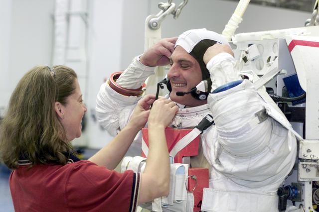 JSC2002-E-27056 (1 July 2002) --- Astronaut David A. Wolf, STS-112 mission specialist, attired in a training version of the Extravehicular Mobility Unit (EMU) space suit, is about to begin a training session in the Neutral Buoyancy Laboratory (NBL) near the Johnson Space Center (JSC). Astronaut Pamela A. Melroy, pilot, assisted Wolf.