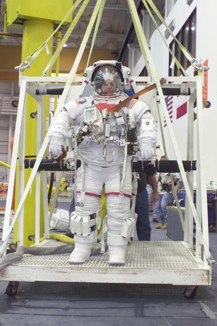 JSC2002-E-27064 (1 July 2002) --- Astronaut David A. Wolf, STS-112 mission specialist, attired in a training version of the Extravehicular Mobility Unit (EMU) space suit, is about to be submerged in the waters of the Neutral Buoyancy Laboratory (NBL) near the Johnson Space Center (JSC).