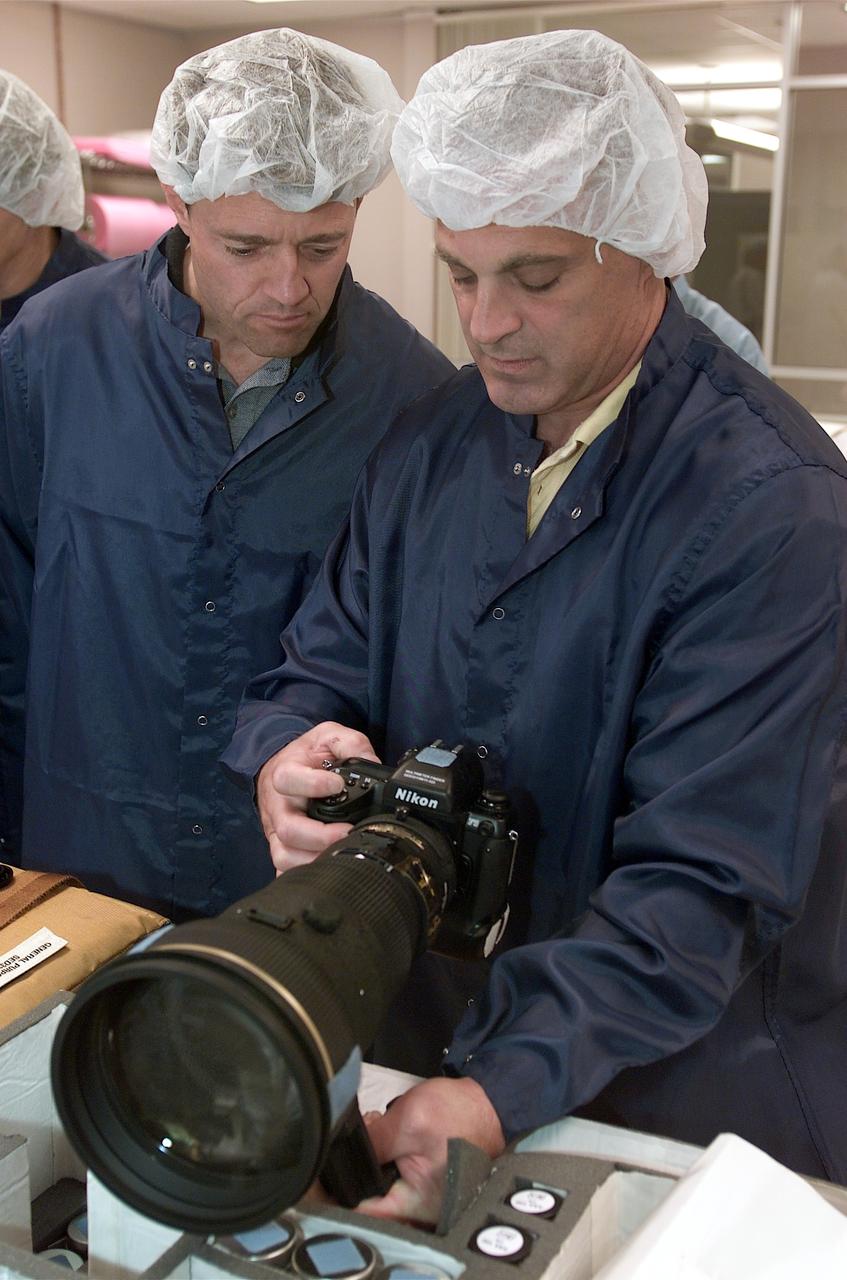 JSC2002-E-30478 (29 July 2002) --- Astronauts Jeffrey S. Ashby (left) and David A. Wolf, STS-112 mission commander and mission specialist, respectively, inspect flight hardware during a crew equipment bench review in an offsite facility near the Johnson Space Center (JSC).