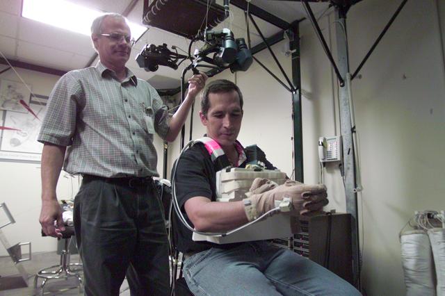 JSC2002-E-33425 (9 August 2002) --- Astronaut John B. Herrington, STS-113 mission specialist, prepares to use virtual reality hardware in the Space Vehicle Mockup Facility at the Johnson Space Center (JSC) to rehearse some of his duties on the upcoming mission to the International Space Station (ISS). David J. Homan assisted Herrington.