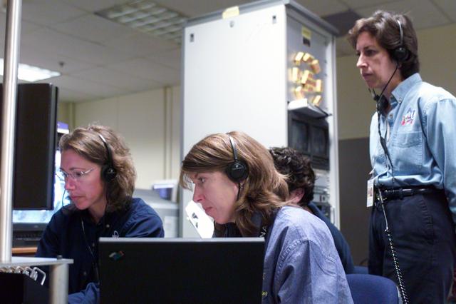 JSC2002-E-34625 (21 Aug. 2002) --- Astronaut Sandra H. Magnus (left), STS-112 mission specialist, uses the virtual reality lab at NASA?s Johnson Space Center (JSC) to train for her duties aboard the space shuttle Atlantis. This type of computer interface paired with virtual reality training hardware and software helps to prepare the entire team for dealing with ISS elements. Lead SSRMS instructor Elizabeth C. Bloomer assisted Magnus. Astronaut Ellen Ochoa (standing) looks on. Photo credit: NASA