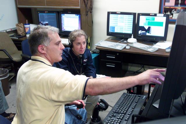 JSC2002-E-34627 (21 August 2002) --- Astronauts David A. Wolf (foreground) and Pamela A. Melroy, STS-112 mission specialist and pilot, respectively, use the virtual reality lab at the Johnson Space Center (JSC) to train for their duties aboard the Space Shuttle Atlantis. This type of computer interface paired with virtual reality training hardware and software helps to prepare the entire team for dealing with ISS elements.