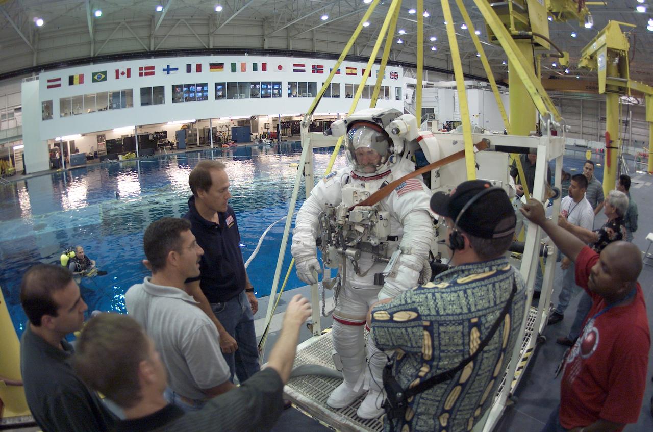 JSC2002-E-37424 (6 September 2002) --- Astronaut Joseph R. (Joe) Tanner, STS-115 mission specialist, attired in a training version of the Extravehicular Mobility Unit (EMU) space suit, is about to be submerged in the waters of the Neutral Buoyancy Laboratory (NBL) near the Johnson Space Center (JSC).