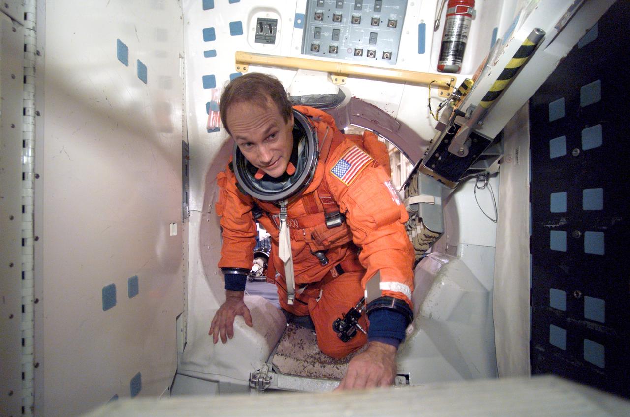 JSC2002-E-44130 (31 October 2002) --- Astronaut Steven G. MacLean, STS-115 mission specialist, participates in a mission training session in one of the high fidelity trainer/mockups in the Space Vehicle Mockup Facility at the Johnson Space Center (JSC). MacLean, who represents the Canadian Space Agency, is attired in a training version of the shuttle launch and entry suit.