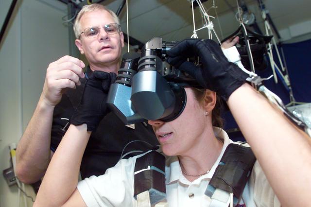 JSC2002-E-51049 (16 Dec. 2002) --- Astronaut Heidemarie M. Stefanyshyn-Piper, STS-115 mission specialist, uses specialized gear during a training session in the virtual reality lab at the Johnson Space Center (JSC) to rehearse some of her duties on the upcoming mission to the International Space Station (ISS). David J. Homan assisted Stefanyshyn-Piper.