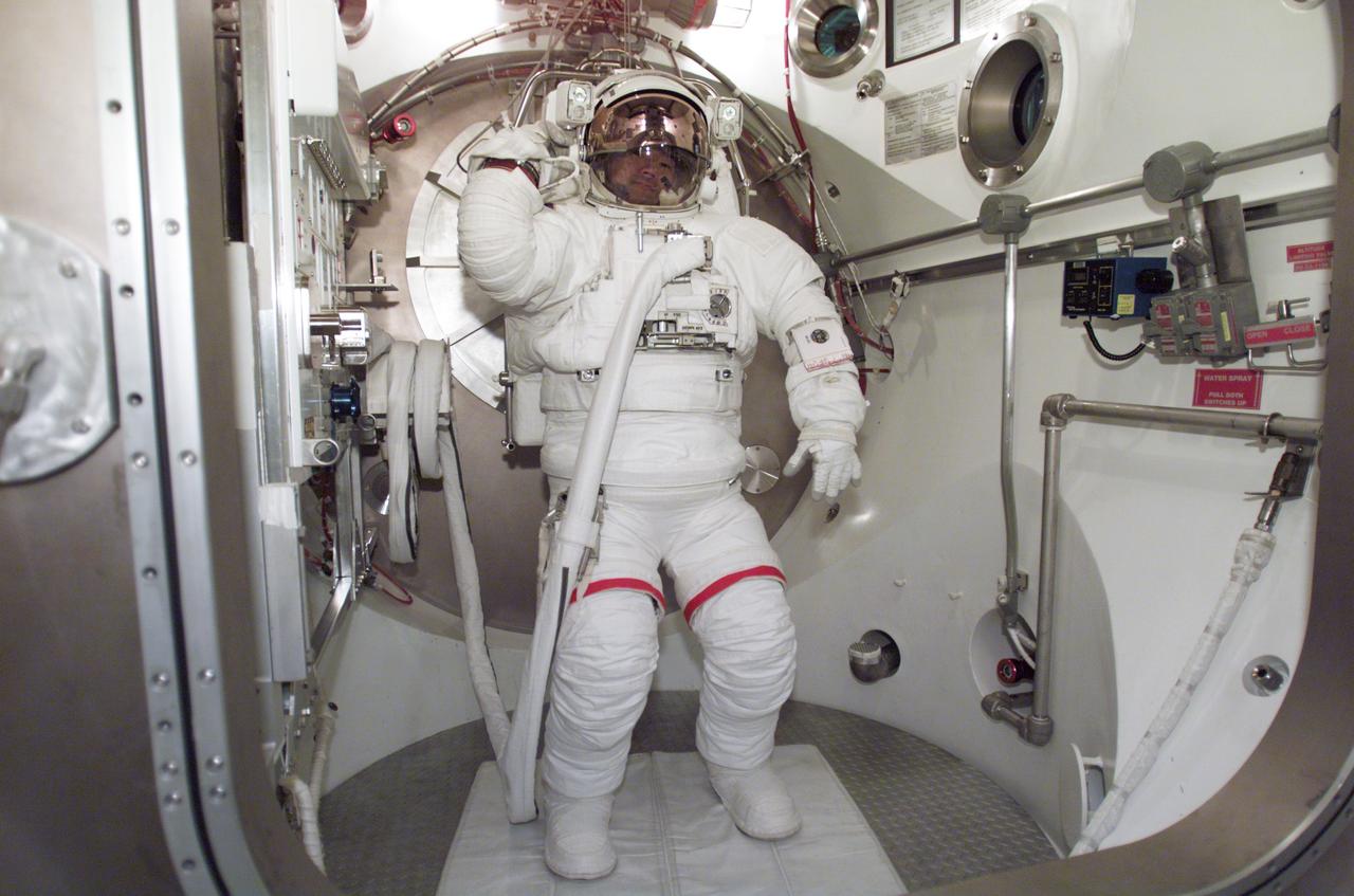 JSC2003-E-01132 (10 January 2003) --- Astronaut Soichi Noguchi, STS-114 mission specialist, participates in an Extravehicular Mobility Unit (EMU) spacesuit fit check in the Space Station Airlock Test Article (SSATA) in the Crew Systems Laboratory at the Johnson Space Center (JSC). Noguchi represents the Japanese Space Agency.