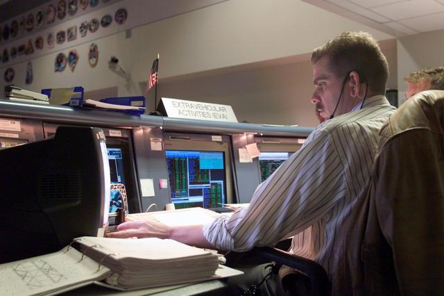 JSC2003-E-02160 (15 January 2003) --- Chris Looper, EVA officer, monitors data at his console in the station flight control room (BFCR) in Houston&#0146;s Mission Control Center (MCC). At the time this photo was taken, astronauts Kenneth D. Bowersox and Donald R. Pettit, Expedition Six mission commander and NASA ISS science officer, respectively, were participating in the mission&#0146;s only scheduled session of extravehicular activity (EVA).
