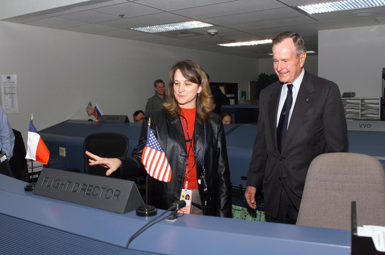 JSC2003-E-05202 (3 February 2003) --- In the Station Flight Control Room of JSC's Mission Control Center, former President George H.W.  Bush learns about current activity aboard the Earth-orbiting International Space Station (ISS) from Flight Director Sally Davis.  The former Chief Executive and First Lady visited the Houston facility on Feb. 3, 2003.