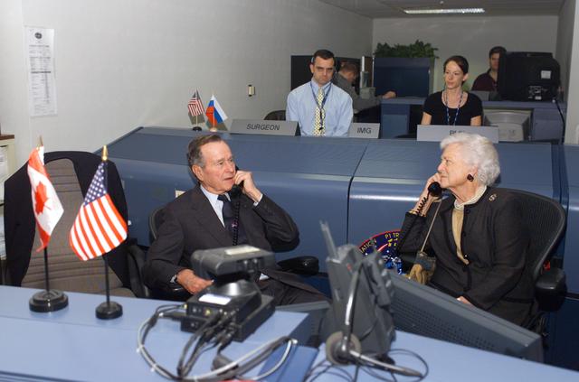 NASA image: Former President George H. W. Bush and Mrs. Bush visit with Mission Control Center personnel.