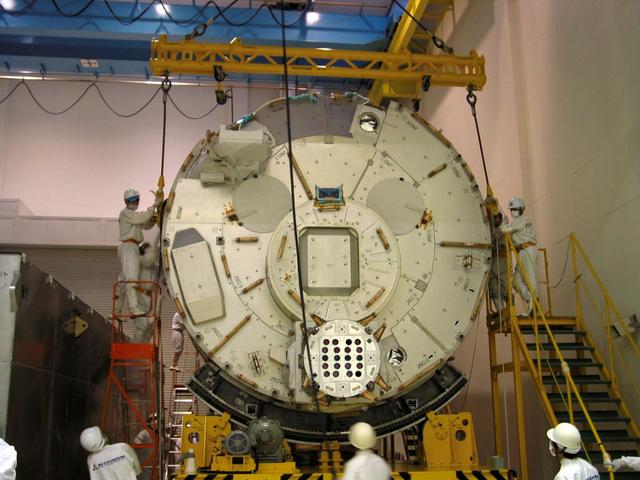 JSC2003-E-34755 (16 April 2003) --- Workers at Japan's Tsukuba Space Center are shown preparing the Japanese Experiment Module (JEM), Kibo, for lifting and packaging into an environmentally controlled shipping container for its transportation to Yokohama Harbor, where it was loaded on a container ship bound for Port Canaveral, Florida. The Kibo Pressurized Module, built by the National Space Development Agency of Japan (NASDA), is expected to arrive at the Kennedy Space Center for module integration tests with Node 2 and pre-launch processing in early June. Photo Credit: NASA