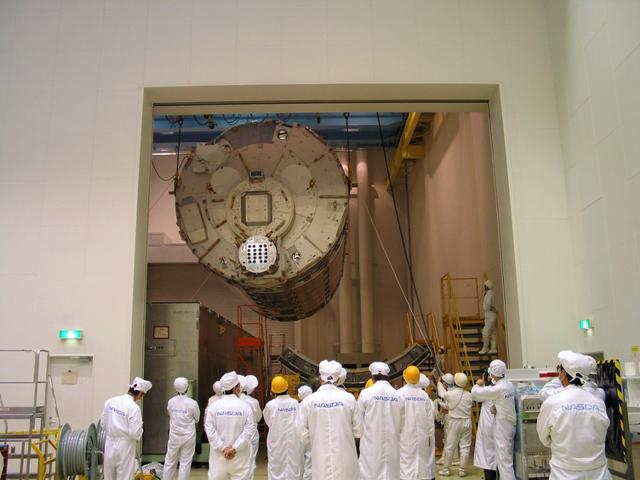 JSC2003-E-34757 (16 April 2003) --- The Kibo Japanese Experiment Module's (JEM) Pressurized Module, a science laboratory bound for the International Space Station, is lowered into an environmentally controlled shipping container, in preparation for shipment to the Kennedy Space Center where it will be prepared for launch aboard the Space Shuttle. A container transport ship carrying Kibo left Yokohama Harbor, Japan, May 2, 2003, bound for Port Canaveral, Florida. The Kibo laboratory, built by the National Space Development Agency of Japan (NASDA), is expected to arrive at the Kennedy Space Center for module integration tests with Node 2 and pre-launch processing in early June. Photo Credit: NASA