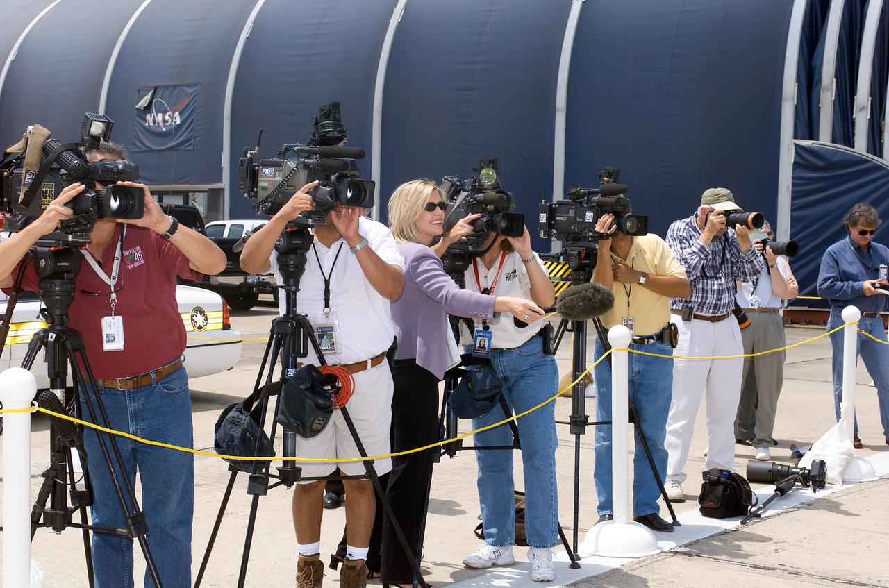 JSC2003-E-37465 (21 May 2003) --- Members of the media are pictured while they watch the arrival of the Expedition 6 crewmembers in a Gulfstream IV aircraft at Ellington Field, near Johnson Space Center (JSC).