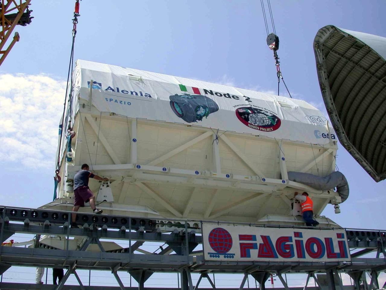 JSC2003-E-40247 (30 May 2003) ---  The International Space Station U.S. Node 2 module is placed into an Airbus Beluga heavy-lift aircraft.  The aircraft departed May 30 from Turin, Italy and arrived at the Kennedy Space Center June 1 with Node 2.  Under contract of the Italian Space Agency (ASI), Alenia Spazio led a consortium of European sub-contractors to build Node 2. The module was built for NASA under a barter agreement with the European Space Agency (ESA) in exchange for the launch of the European Columbus Laboratory by the space shuttle to the International Space Station.  Node 2 will provide a passageway between four International Space Station science experiment modules: the U.S. Destiny Laboratory, the Kibo Japanese Experiment Module, the European Columbus Laboratory and the Centrifuge Accommodation Module.  The addition of Node 2 to the station will signify the U.S. Core Complete stage of assembly, at which time the station can support the addition of international laboratories from Europe and Japan. Photo   Credit: Italian Space Agency (ASI )