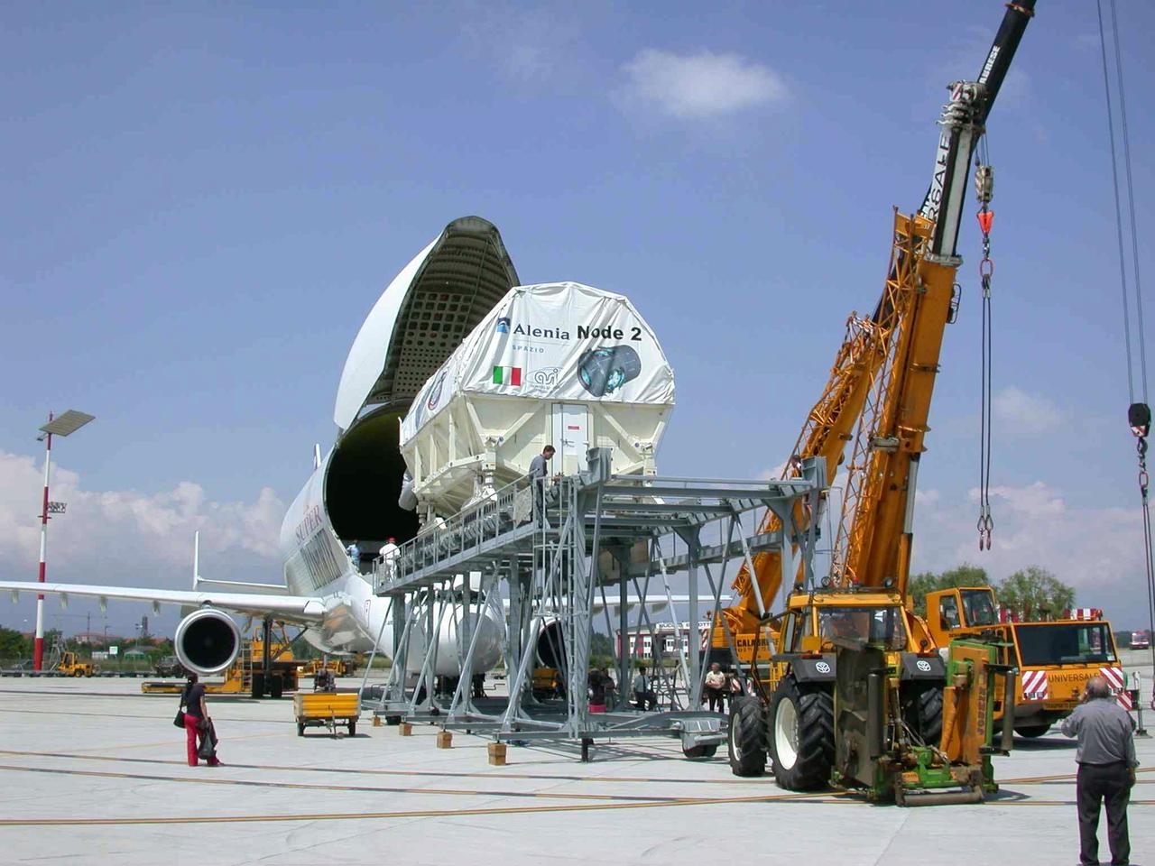JSC2003-E-40248 (30 May 2003) ---  The International Space Station U.S. Node 2 module is placed into an Airbus Beluga heavy-lift aircraft.  The aircraft departed May 30 from Turin, Italy and arrived at the Kennedy Space Center June 1 with Node 2.  Under contract of the Italian Space Agency (ASI), Alenia Spazio led a consortium of European sub-contractors to build Node 2. The module was built for NASA under a barter agreement with the European Space Agency (ESA) in exchange for the launch of the European Columbus Laboratory by the space shuttle to the International Space Station.  Node 2 will provide a passageway between four International Space Station science experiment modules: the U.S. Destiny Laboratory, the Kibo Japanese Experiment Module, the European Columbus Laboratory and the Centrifuge Accommodation Module.  The addition of Node 2 to the station will signify the U.S. Core Complete stage of assembly, at which time the station can support the addition of international laboratories from Europe and Japan. Photo Credit: Italian Space Agency (ASI )