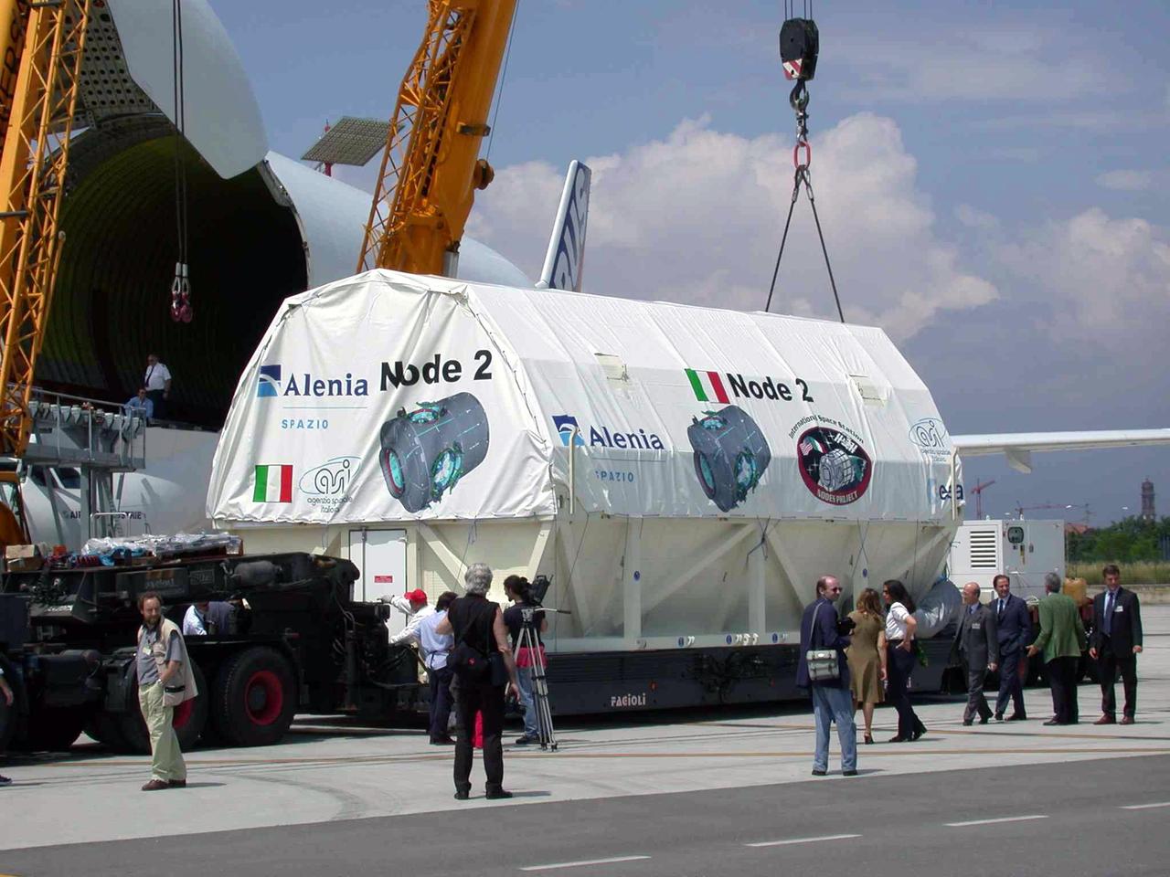 JSC2003-E-40262 (30 May 2003) --- The International Space Station U.S. Node 2 module is brought to an Airbus Beluga heavy-lift aircraft.  The aircraft departed May 30 from Turin, Italy and arrived at the Kennedy Space Center June 1 with Node 2. Under contract of the Italian Space Agency (ASI), Alenia Spazio led a consortium of European sub-contractors to build Node 2. The module was built for NASA under a barter agreement with the European Space Agency (ESA) in exchange for the launch of the European Columbus Laboratory by the space shuttle to the International Space Station. Node 2 will provide a passageway between four International Space Station science experiment modules: the U.S. Destiny Laboratory, the Kibo Japanese Experiment Module, the European Columbus Laboratory and the Centrifuge Accommodation Module.  The addition of Node 2 to the station will signify the U.S. Core Complete stage of assembly, at which time the station can support the addition of international laboratories from Europe and Japan. Photo Credit: Italian Space Agency (ASI)